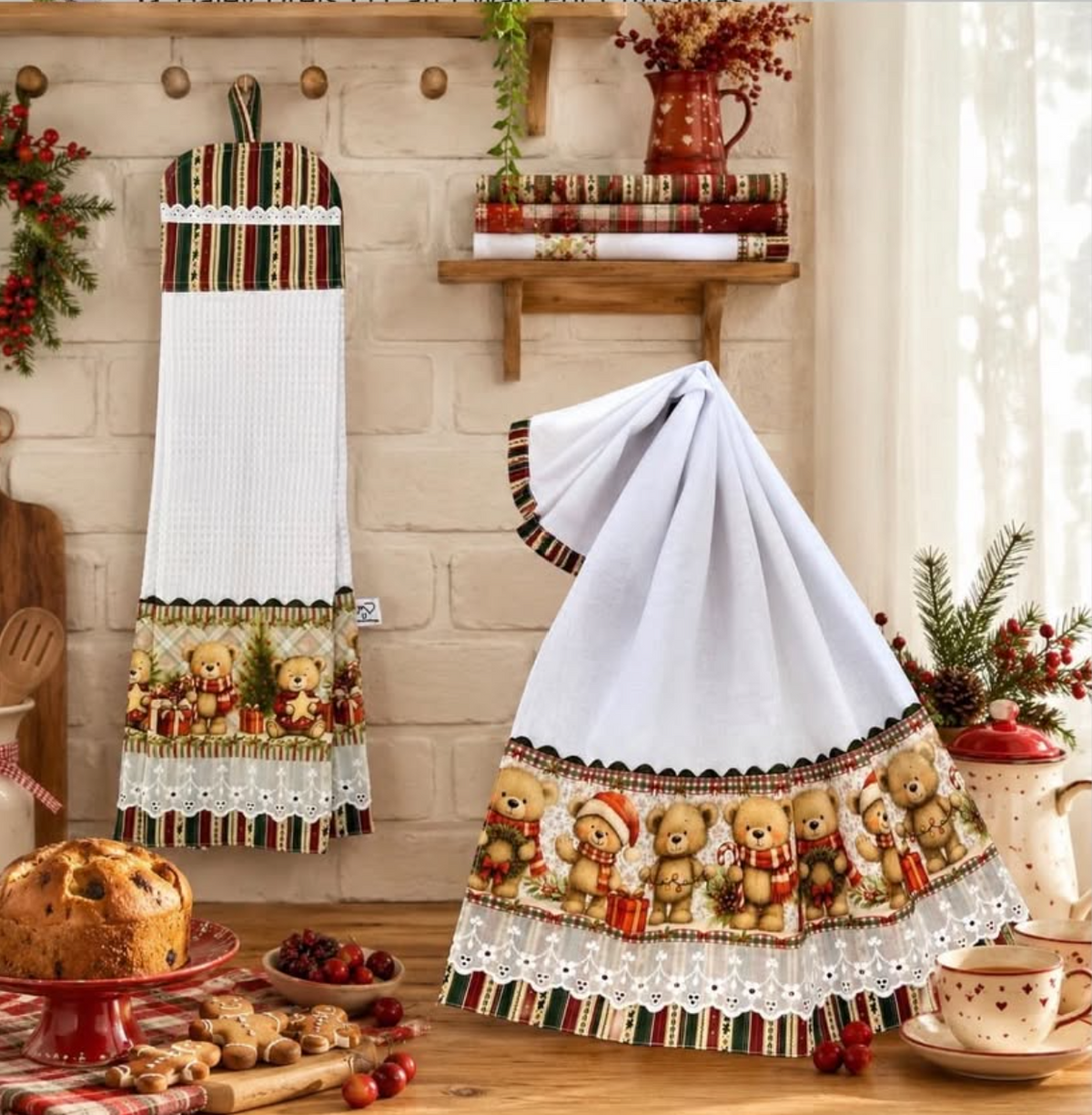 Christmas teddy bear towel set with a white waffle-weave hanging towel and white tea towel, red-and-green striped accents and white eyelet lace in a festive kitchen.