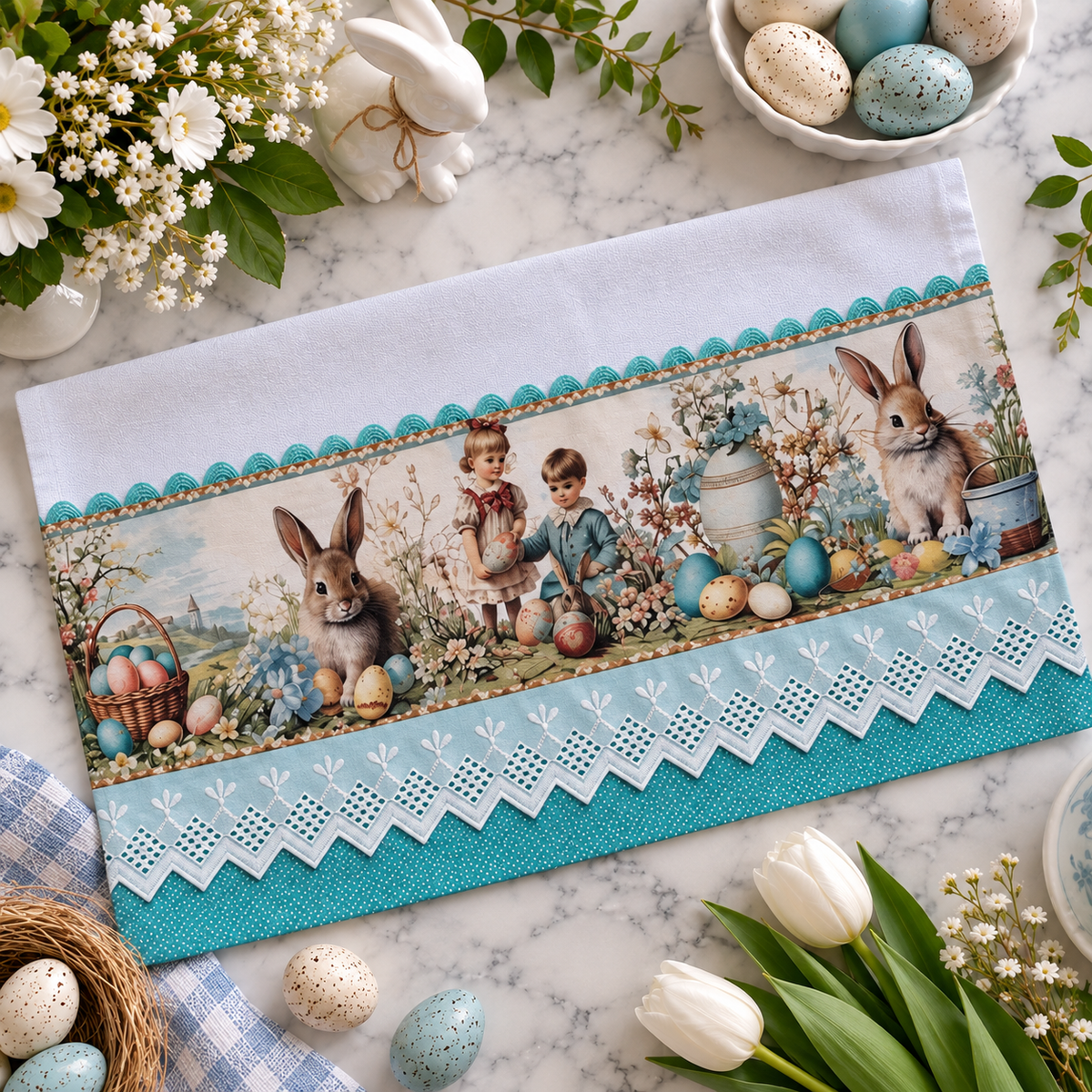 Vintage Easter Garden kitchen tea towel 20x30 flat lay on marble surface showing storybook print panel with children gathering Easter eggs alongside bunnies and spring florals, aqua polka dot trim with white eyelet lace border, surrounded by white tulips, speckled eggs, white bunny figurine, and spring flowers