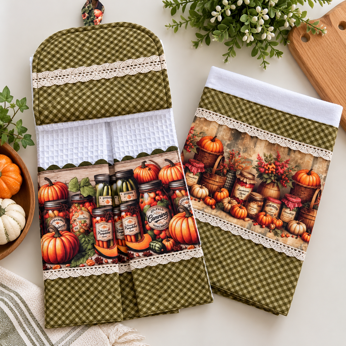 Flat lay of Autumn Pantry hanging towel and tea towel with pumpkin and canning jar prints, white waffle weave, olive check fabric and cream lace trim.